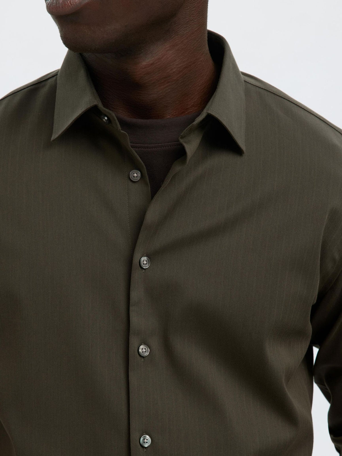 Nærbillede af krave og knapper på Selected Performance Stretch Slim Fit skjorte i Forest Night mørkegrøn